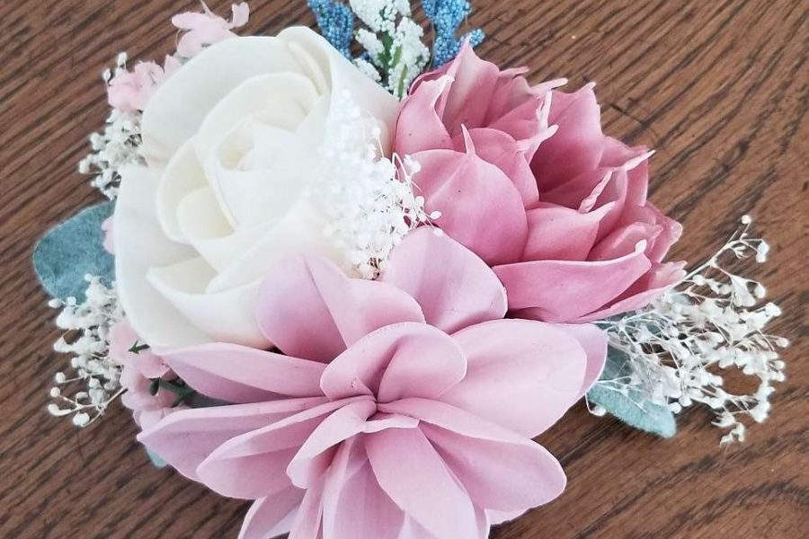 sola flowers in a pink and white corsage